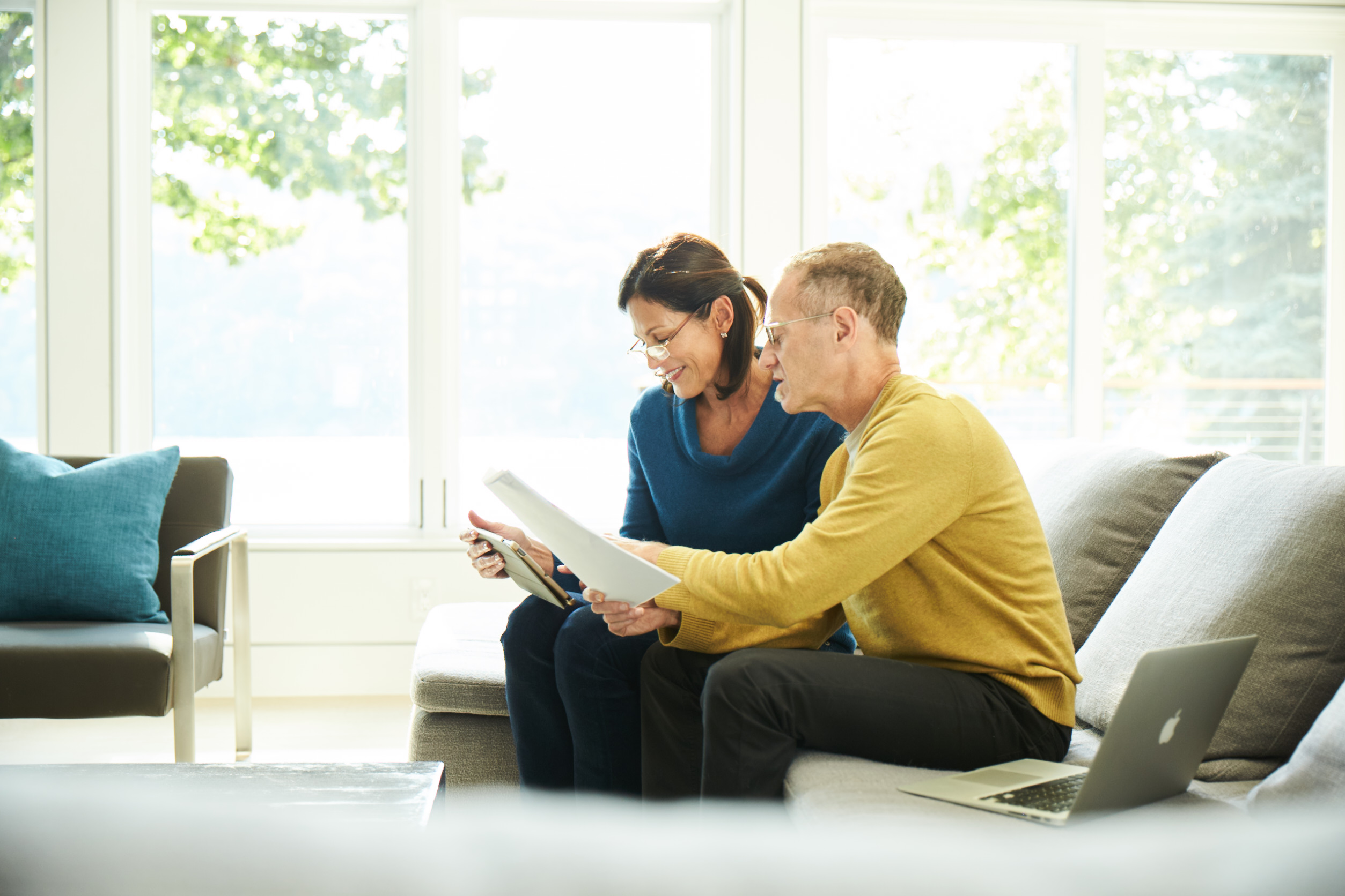 A couple speaking sitting on a couch and discussing regarding insurance