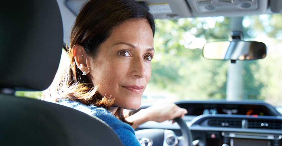 A women confidently driving the car