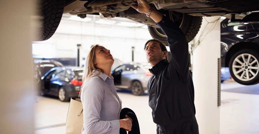 Mechanic showing an issue to a car owner