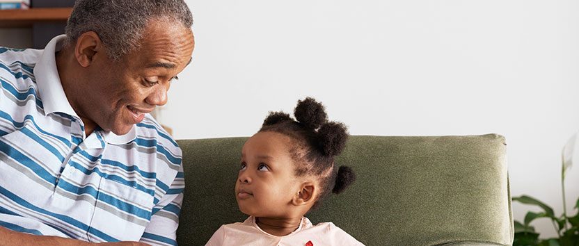 Grandfather narrating a story to his granddaughter